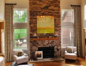 Drapes with geometric pattern on living room windows around fireplace, custom window treatments, buy fabric online, decorator fabric, fabric store.