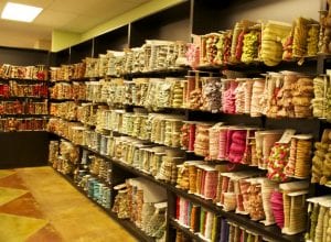 Walls lined with large selection of fabric trim at The Fabric House, online fabric store, buy fabric online, decorator fabric.